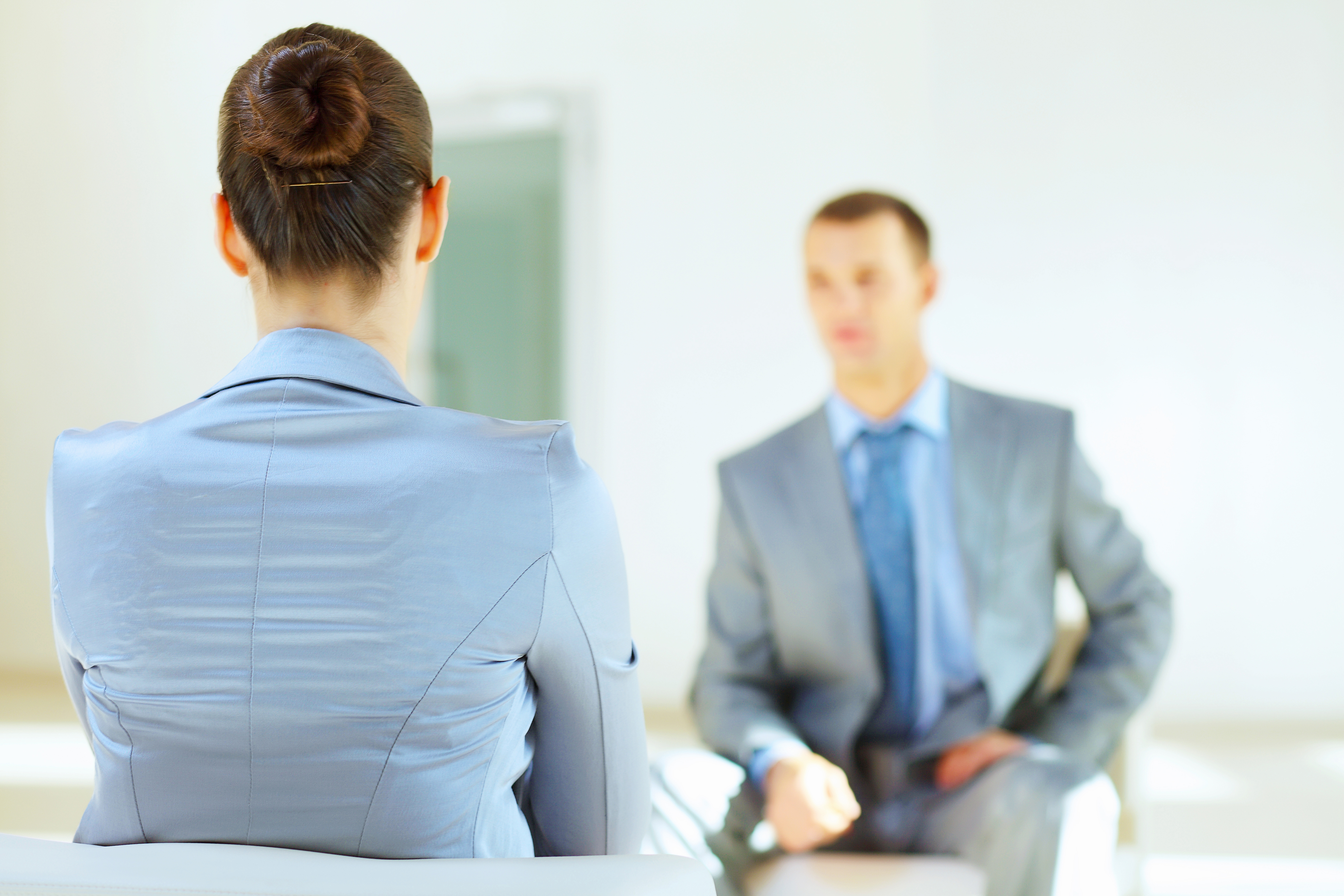 Professional man and woman in a business meeting setting. 