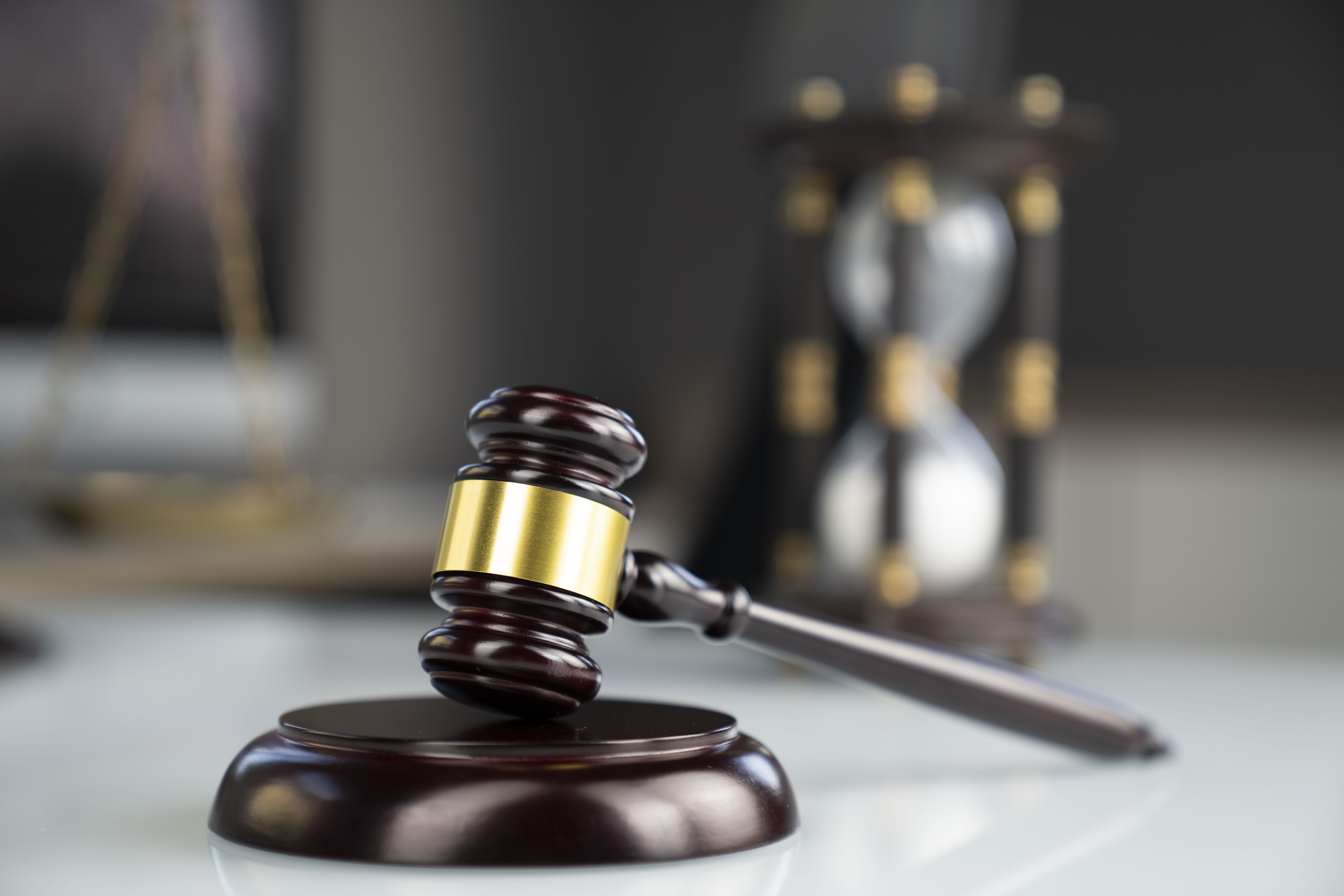 Image of a gavel on the foreground representing employment law. 
