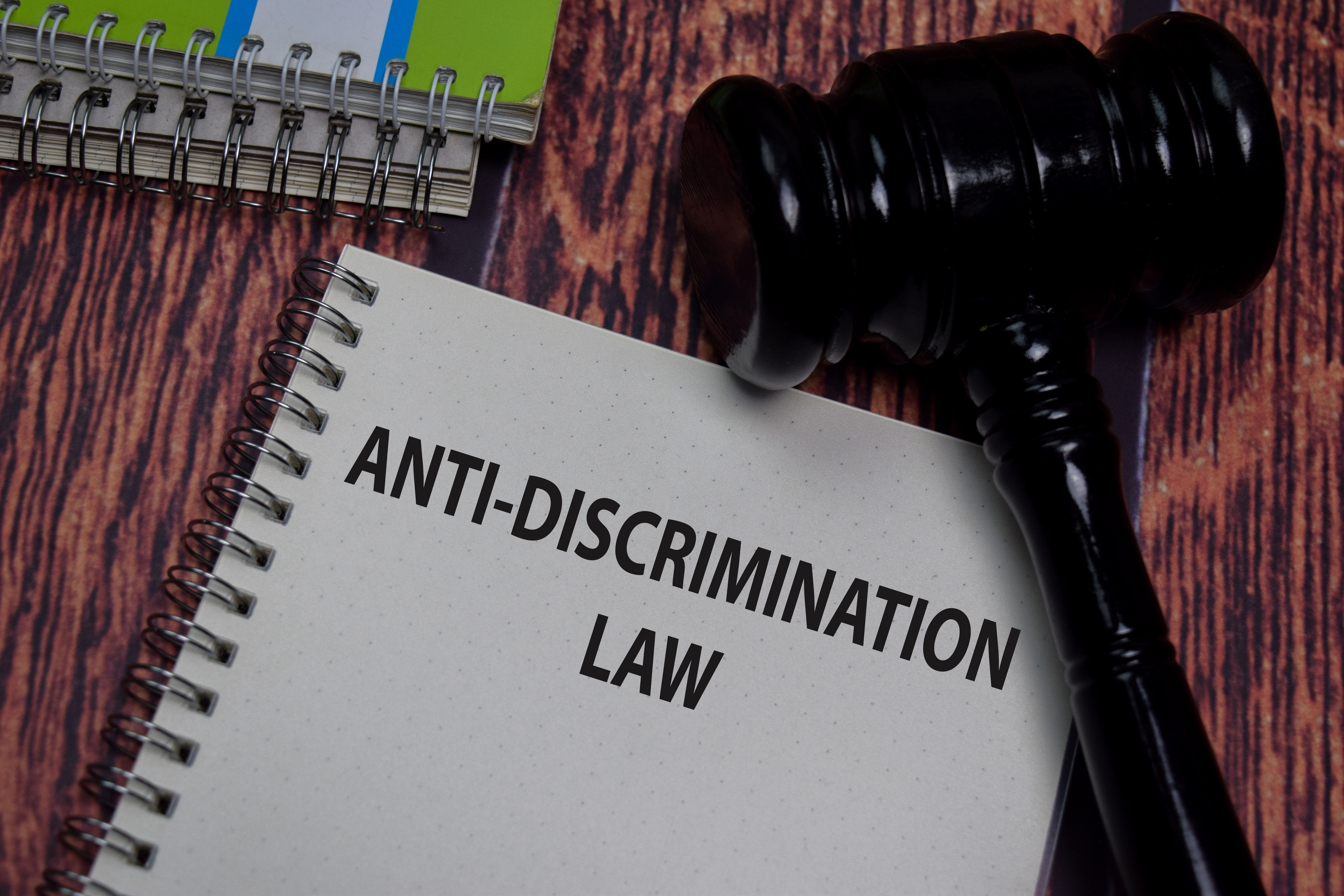 Anti-discrimination law tablet with gavel on desk 