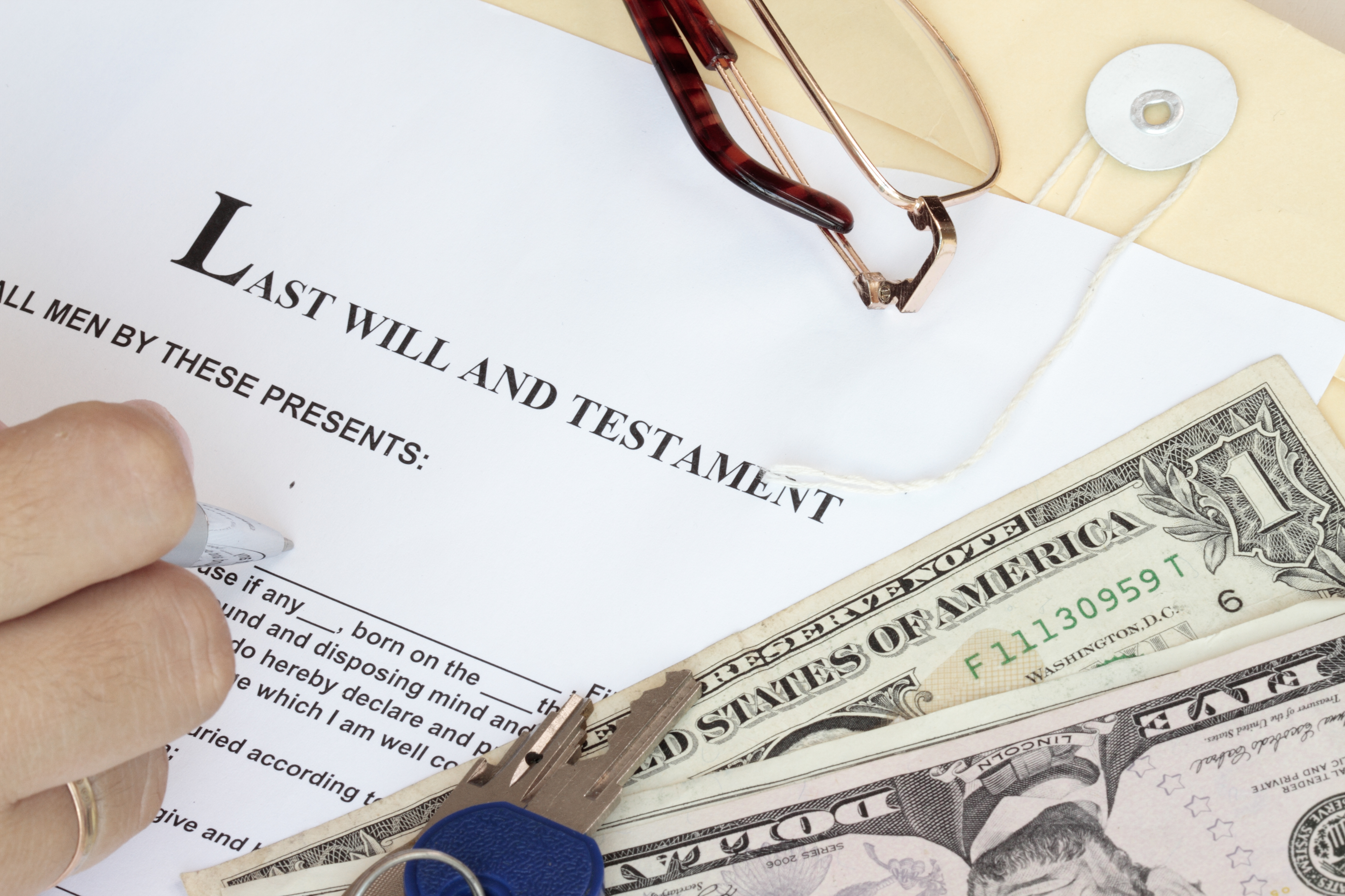 Image of last will and testament with money, keys and glasses symbolizing estate planning in MD, DC and VA. 