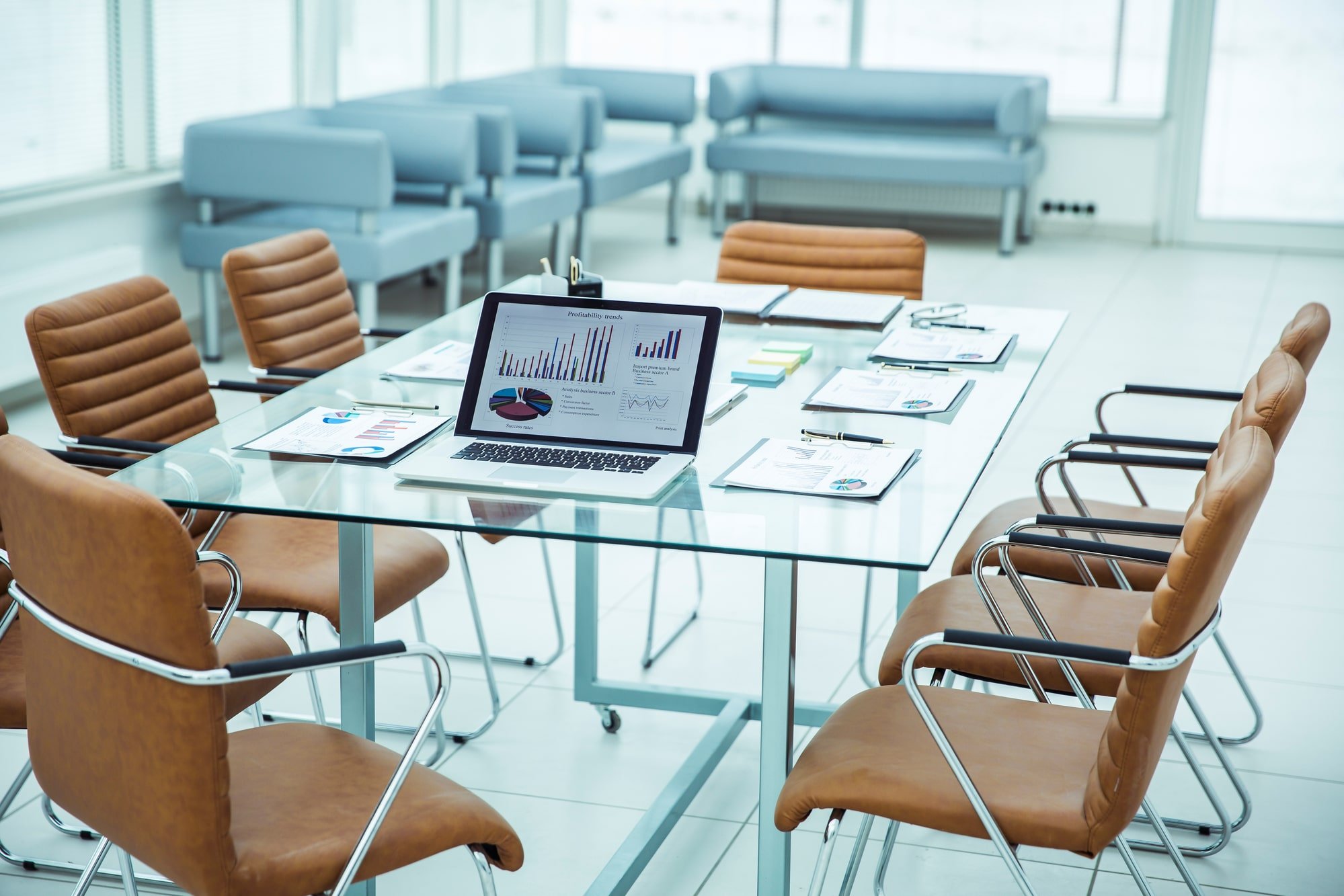 Image of an empty office with documents, a laptop and charts representing a business startup.