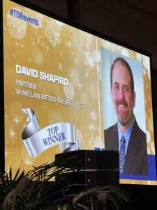 Image of David Shapiro on large screen at the special event
