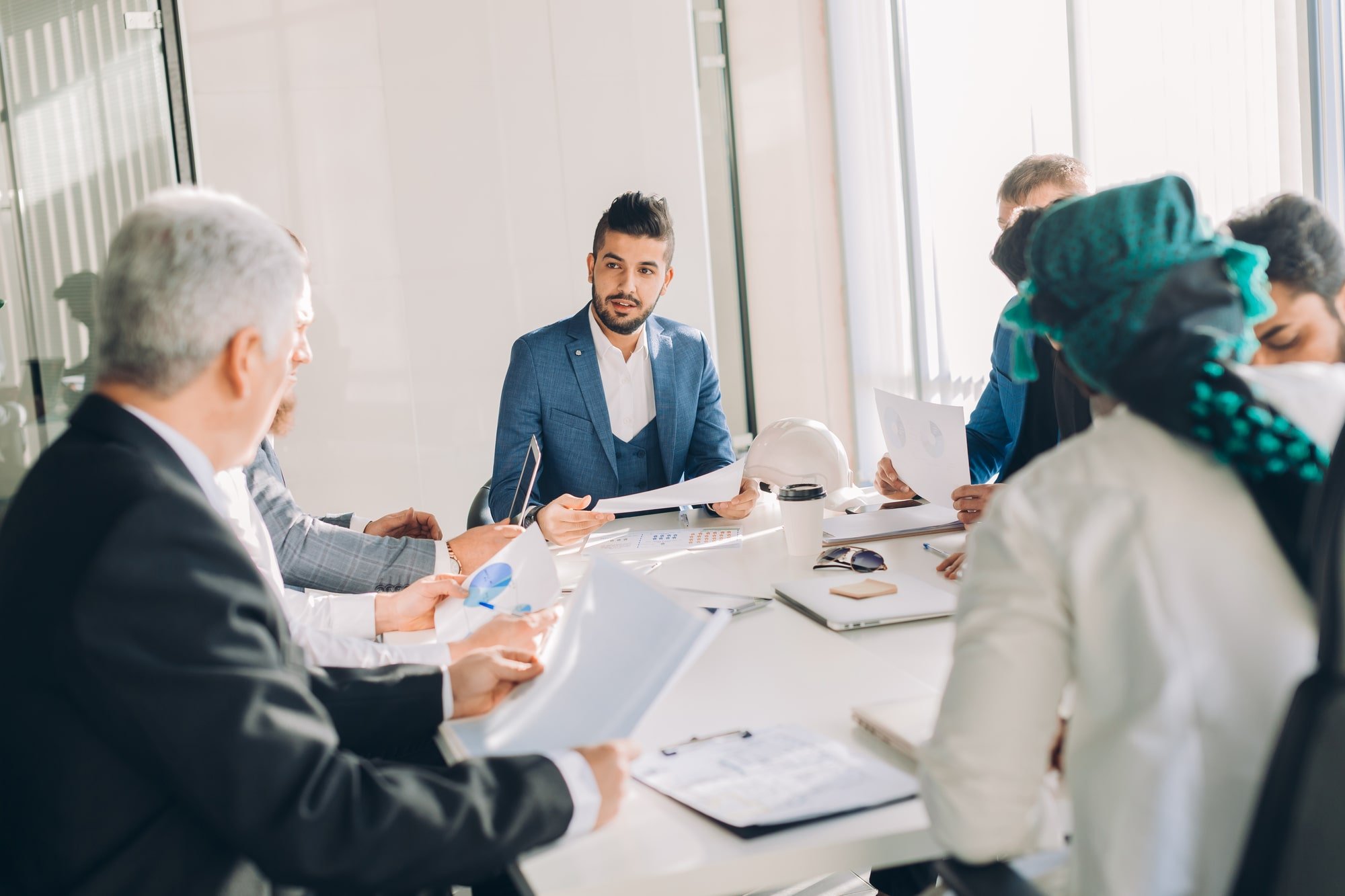 Businesspeople sitting around at a table in a business startup atmosphere.