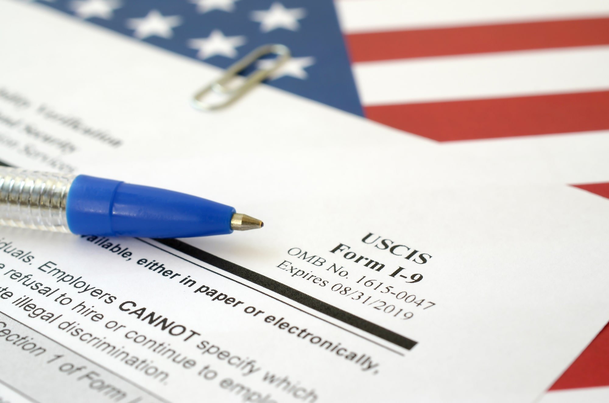 Image of an I9 form laying on top of an American flag.